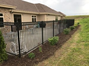 black ornamental fence around the side of house