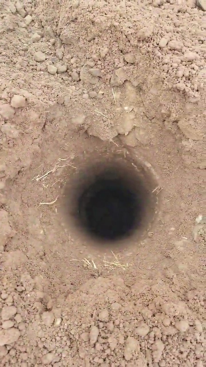 Picture of a post hole dug into frozen ground
