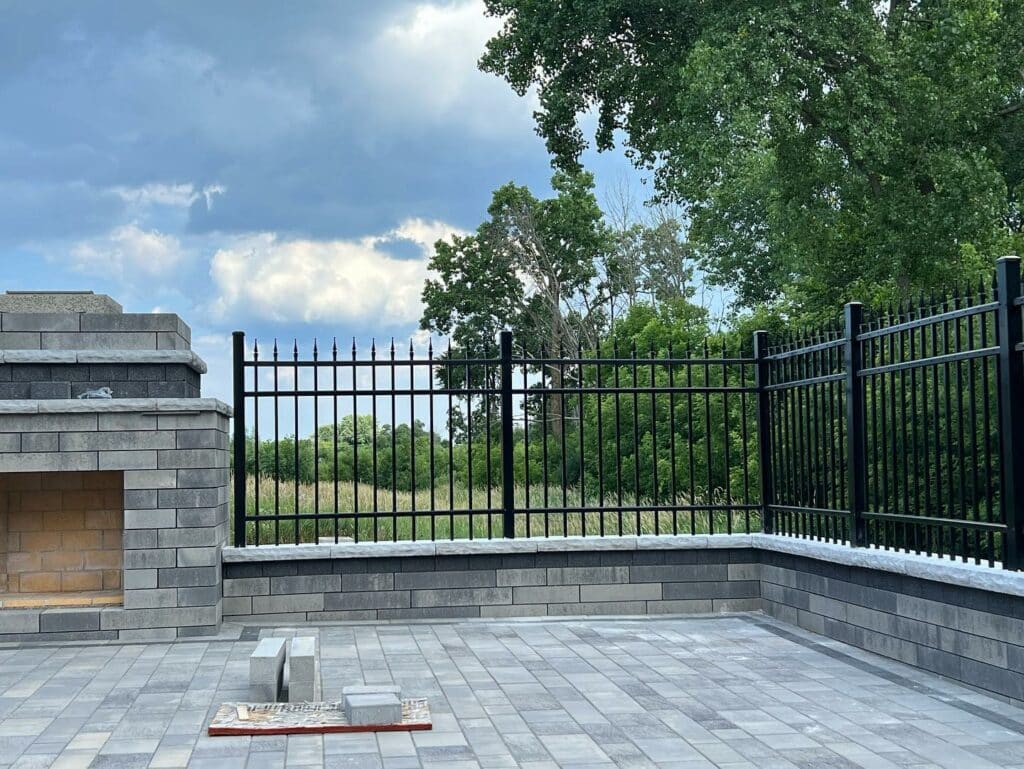 Ornamental Iron Fence; Posts pounded through stone and brick to create a beautiful fence installation.