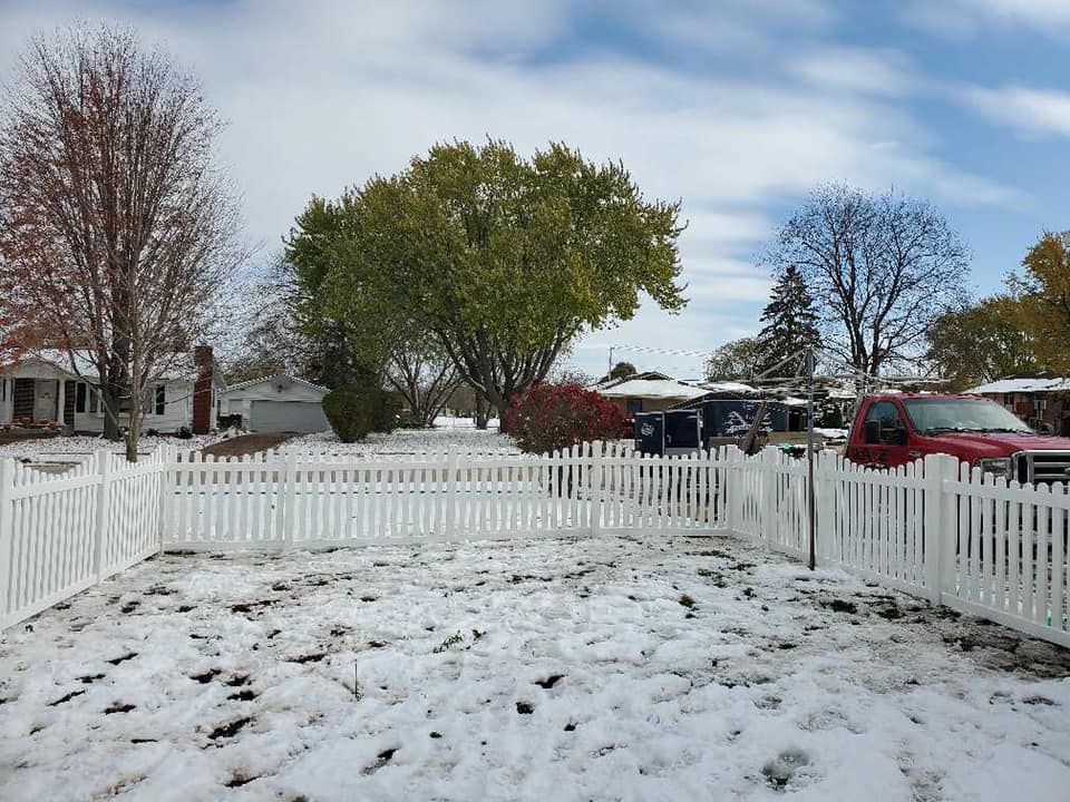 You can install a fence in the winter! Picture shows a vinyl picket fence installed with snow on the ground.